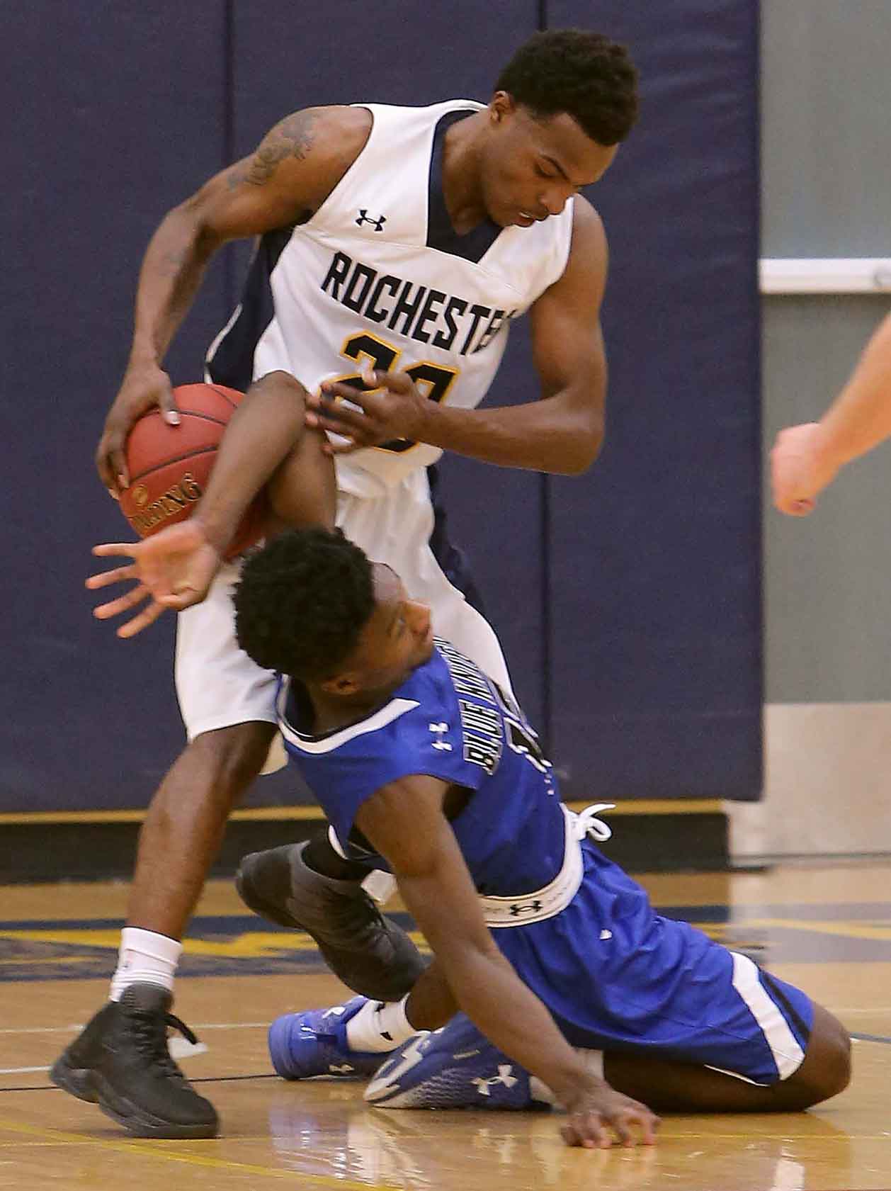 RCTC basketball player mugging a competitor
