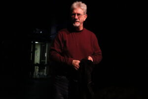 Jerry Casper, February 20, 2026. He is in a red sweater against a black backdrop