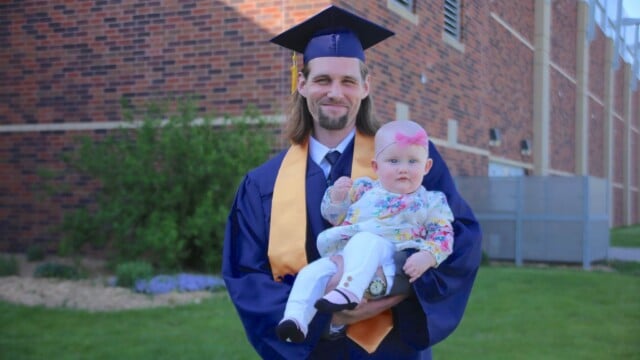 RCTC grad holding a baby