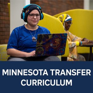 RCTC student wearing headphones sitting at a table with an open laptop